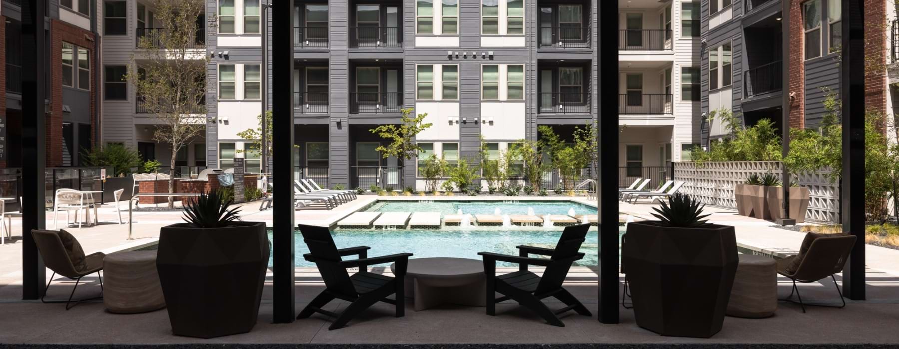 Resort-style pool and lounge seating at Odell Apartments